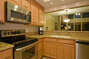 Kitchen has stainless steele appliances and slab granite counters