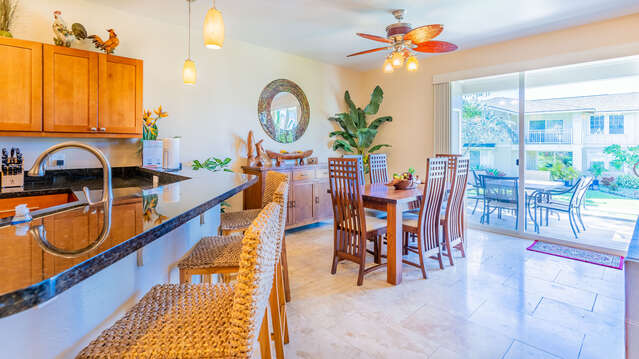 Dining Table, Chairs, Sideboard, Mirror, Ceiling Fan, and Sliding Patio Doors.
