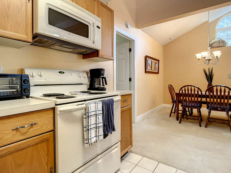 Kitchen with oven range, dishwasher, fridge, and coffee machine in view.