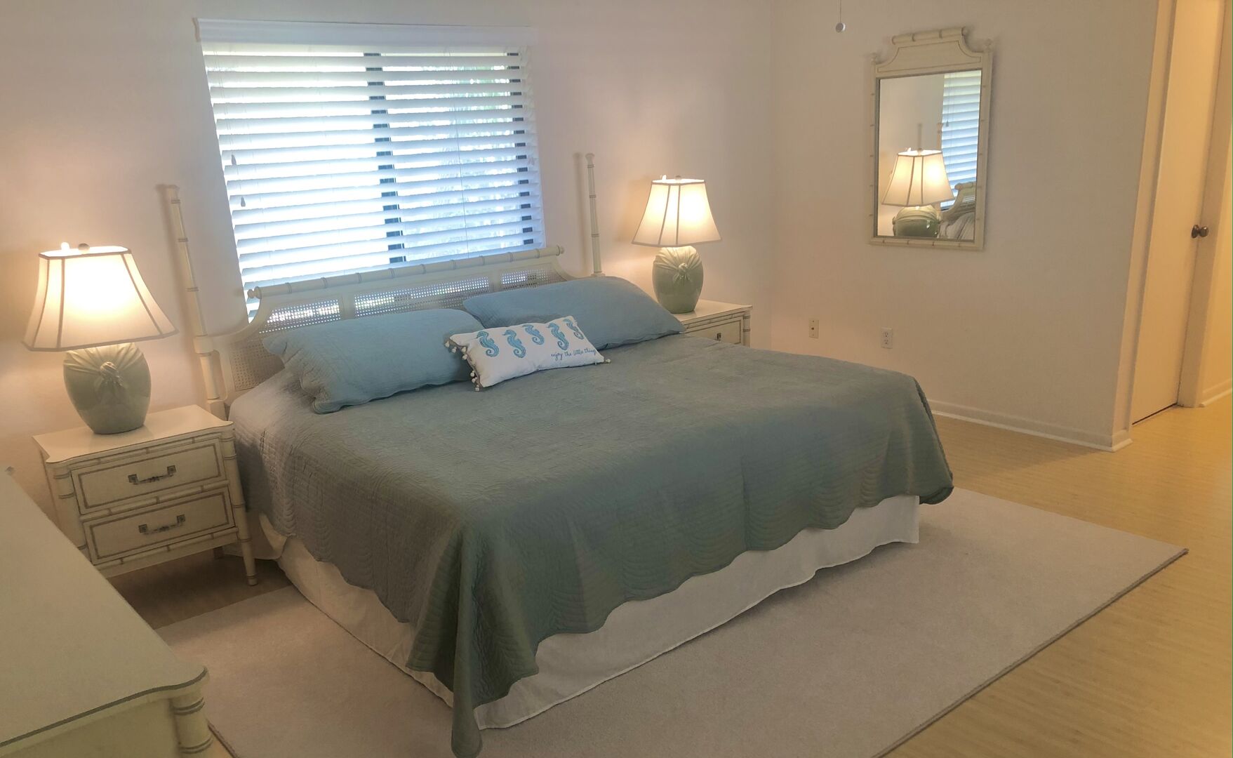 Master bedroom of this villa in New Smyrna Beach with king-size bed, flat screen TV, and private bath.