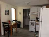 Full kitchen with electric stove, microwave, coffee maker, toaster and new full size refrigerator.