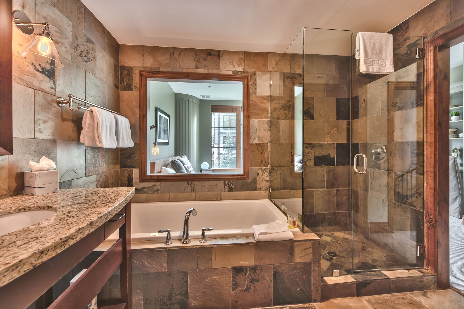 Master Bathroom 3 with a Granite Counter Vanity, a Stone Shower, and a Roman Soaking Tub
