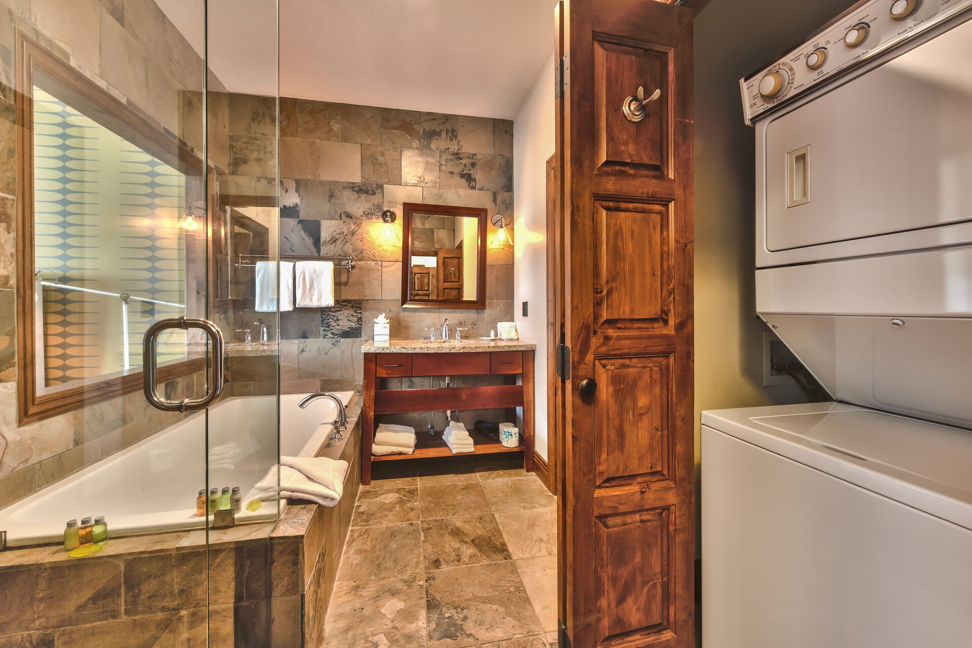 Master Bathroom 2 with a Granite Counter Vanity, a Stone Shower, and a Roman Soaking Tub
