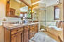 Grand Master Bath with dual stone counter sinks, a tile/glass shower, and jetted tub
