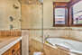 Grand Master Bath with a shower with two shower heads and jetted tub