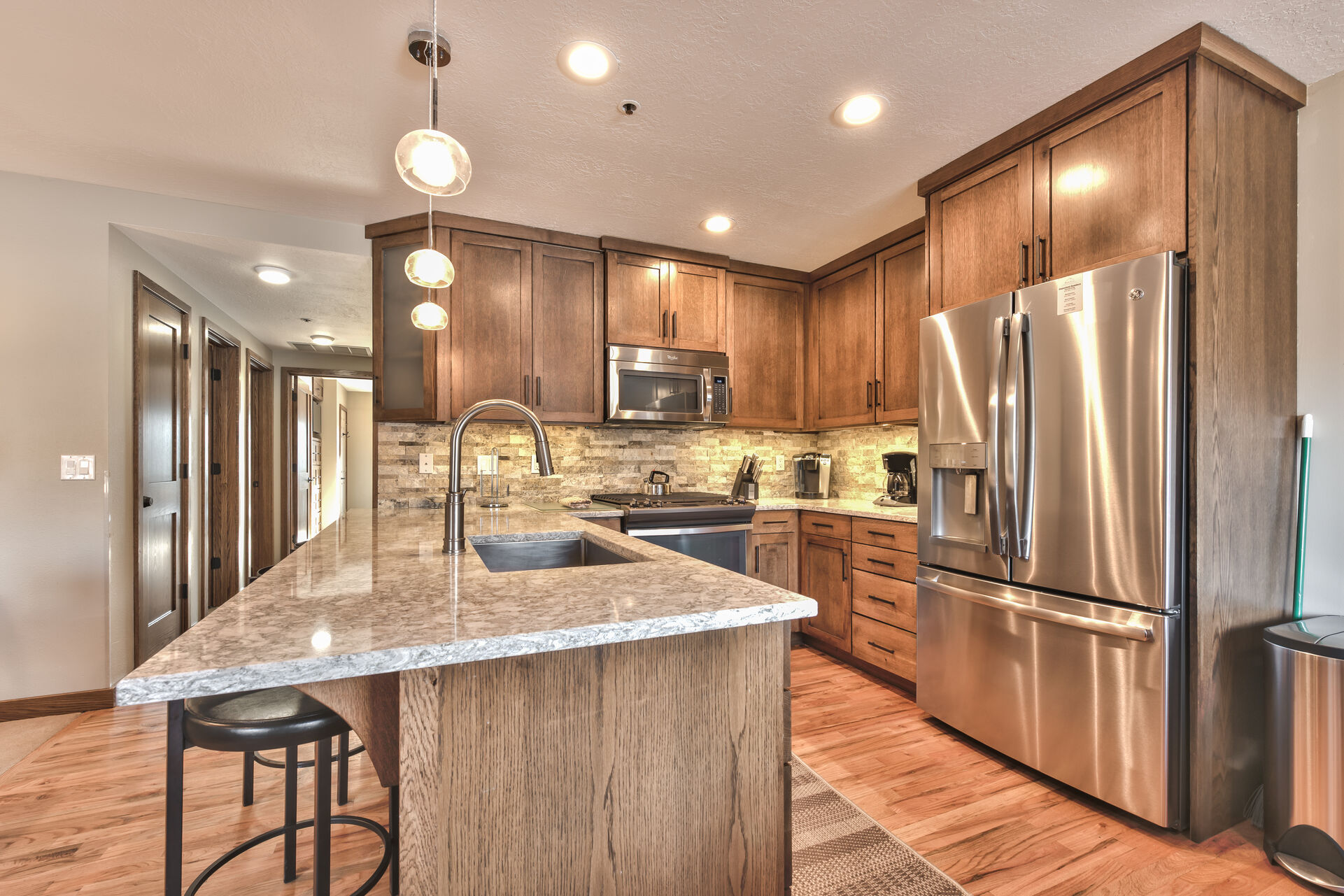 Upgraded Fully Equipped Kitchen with Stainless Steel Appliances, Granite Countertops, and 3-Seat Bar Area