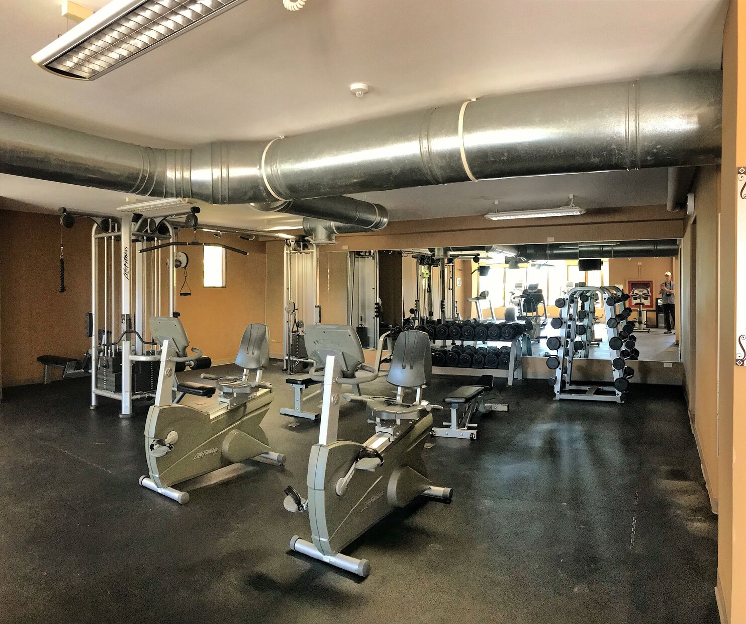 The complete gym includes cardio machines, free weights, as well as resistance machines.