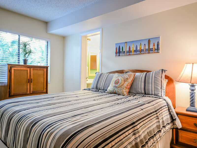 Surf's up in the 2nd bedroom featuring a queen size bed.