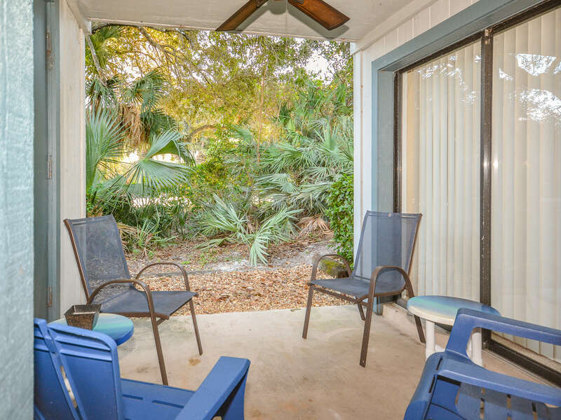 Private patio of this Pet Friendly Condo in New Smyrna Beach FL with views of the tropical Florida landscaping.
