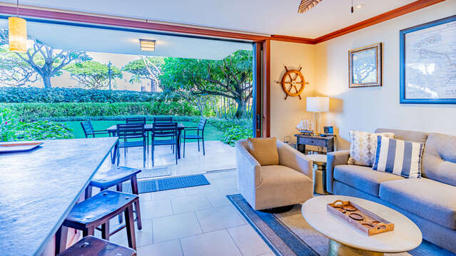 This vacation rental in Ko Olina Oahu has an open layout with sliding doors that open to a beautiful patio and yard.
