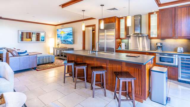 This vacation rental in Ko Olina Oahu has a Roy Yamaguci Designed Kitchen, complete with fridge, ovens, wine fridge, and island with bar seating.