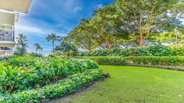 Garden off Lanai with meticulously manicured lawn and island landscaping.