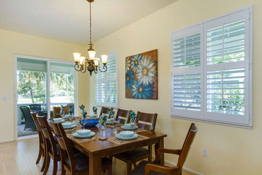 Dining Table with Chairs, Ceiling Lamp, and Patio Sliding Door.
