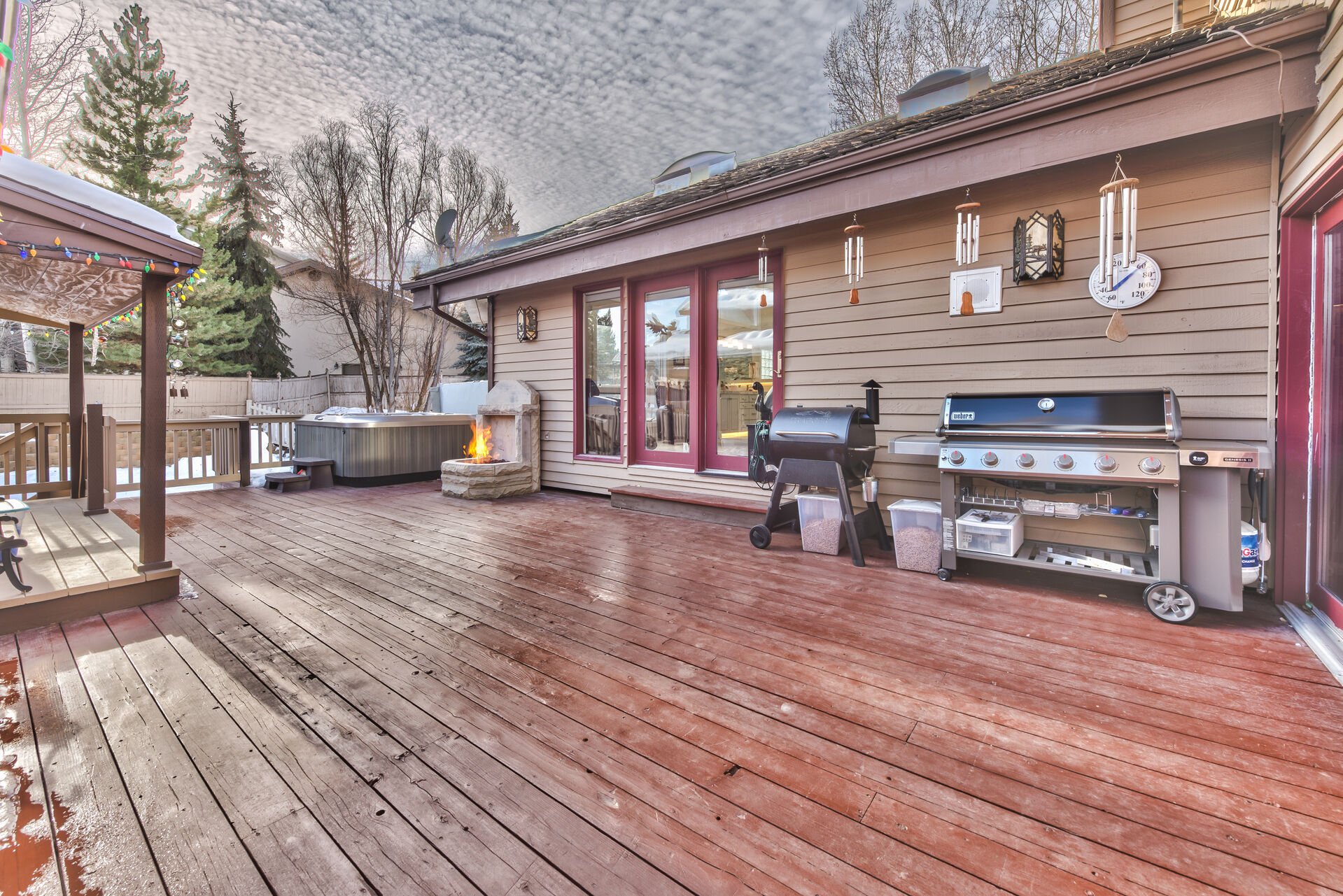 Spacious private deck with two stainless steel BBQ grills, hot tub and kids playhouse, and large back yard