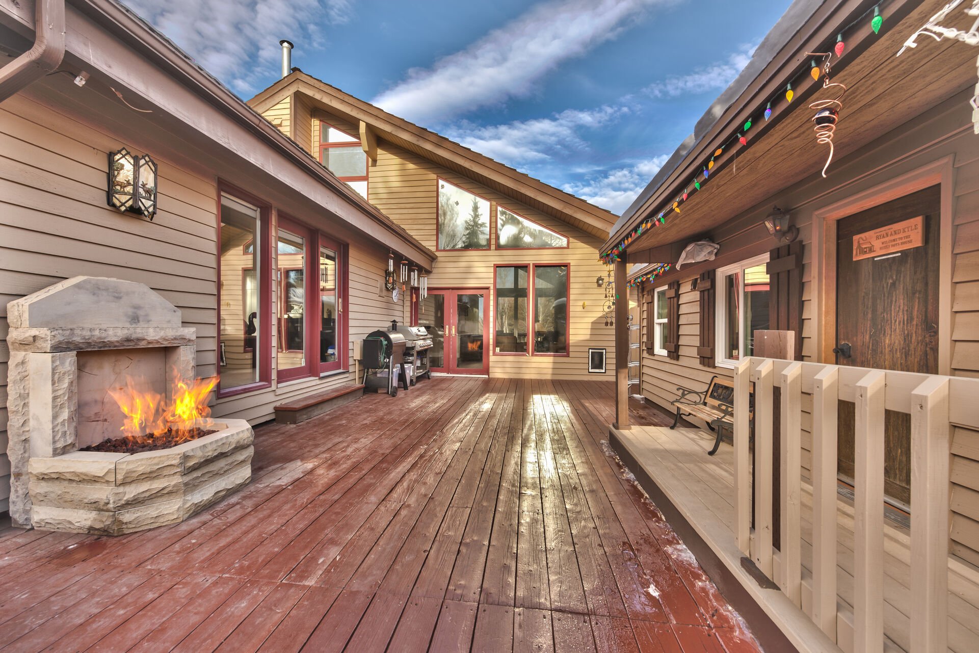 Spacious private deck with two stainless steel BBQ grills, hot tub and kids playhouse, and gas fireplace