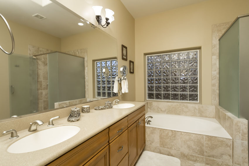 Master bathroom has two sinks, a walk in closet, and a large soaking tub.