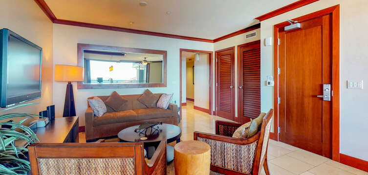 Living Area with Sofa, Armchairs, Coffee Table, and TV.