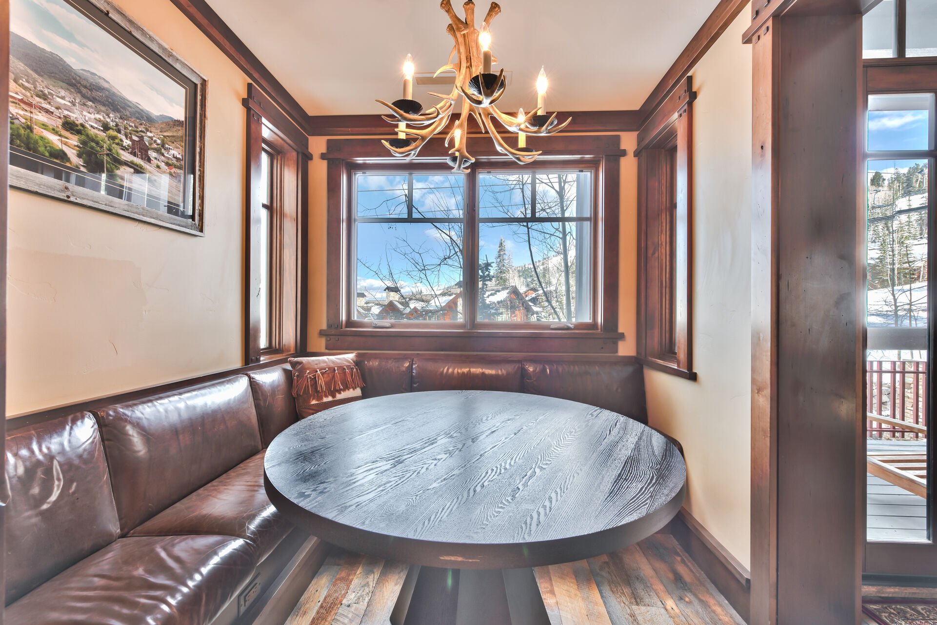 Kitchen table with built-in bench seating and ski slope views