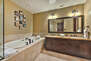 Grand Master bathroom with stone shower, tub, and dual vanities