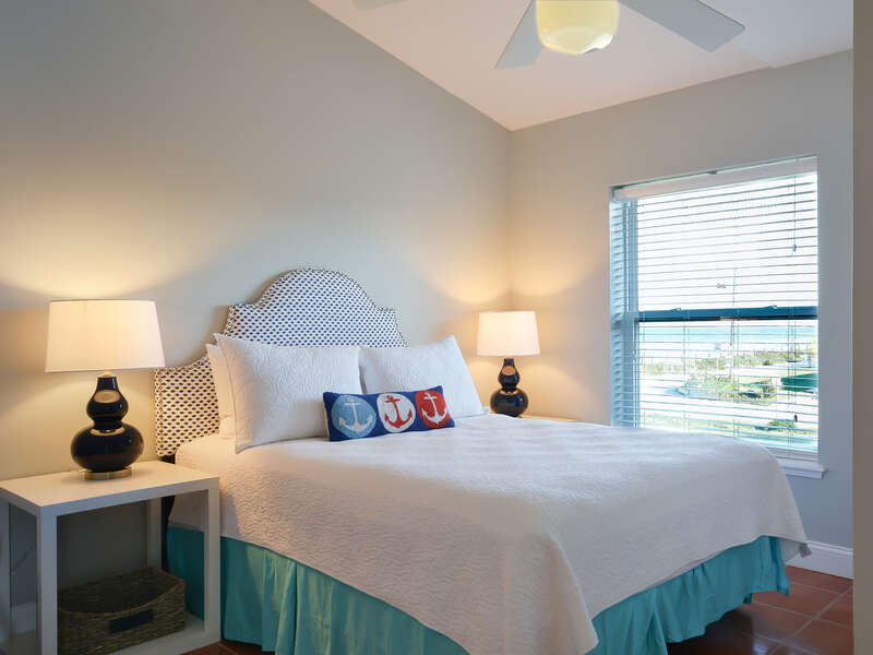 2nd bedroom featuring a ocean view and queen size bed.