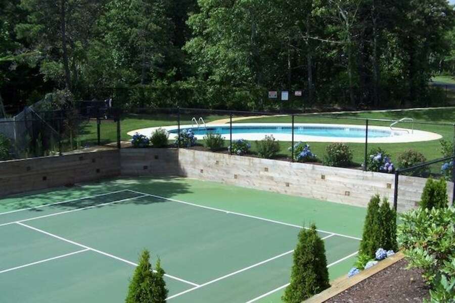 Community Tennis Court with view of pool. Enjoy both of these amenities only 130 steps from the home! - 2 Captains Row E Chatham Cape Cod New England Vacation Rentals-#BookNEVRDirectCaptainsRow