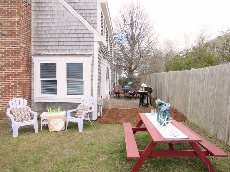 The back yard offers a picnic table and gas grill - 15 Oyster Drive- Chatham- Cape Cod -New England Vacation Rentals