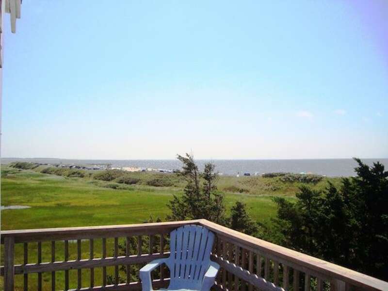 View from upper deck off of the dining area. Table and chairs provided with umbrella - 17 Uncle Venies South Harwich Cape Cod New England Vacation Rentals
