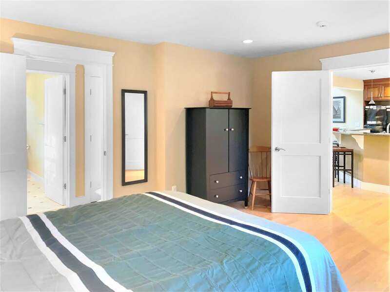 1st floor bedroom with a Queen bed with dual entrances to kitchen and hallway  -  22 Charlene Lane- Harwich- Cape Cod- New England Vacation Rentals