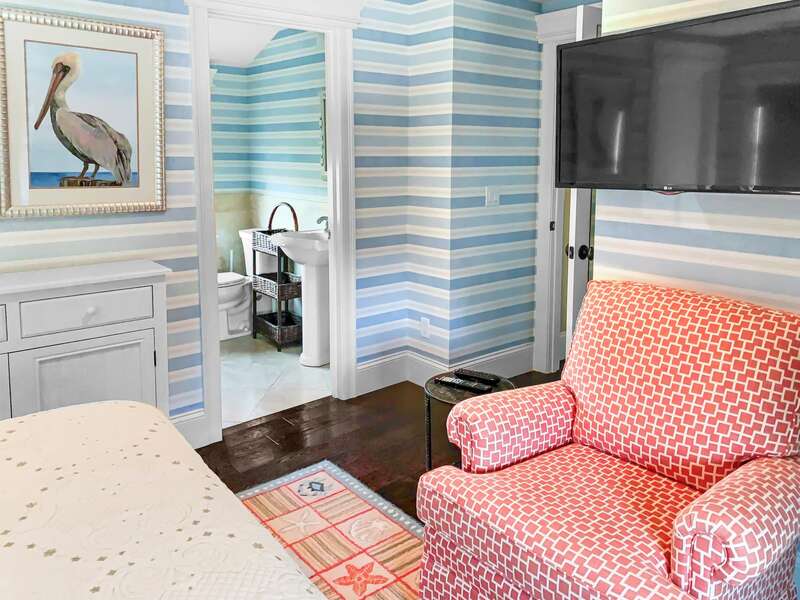 Bedroom 1 has an en suite bathroom with a shower and a flat screen tv - 32 Bearses By Way- Chatham Cape Cod New England Vacation Rentals