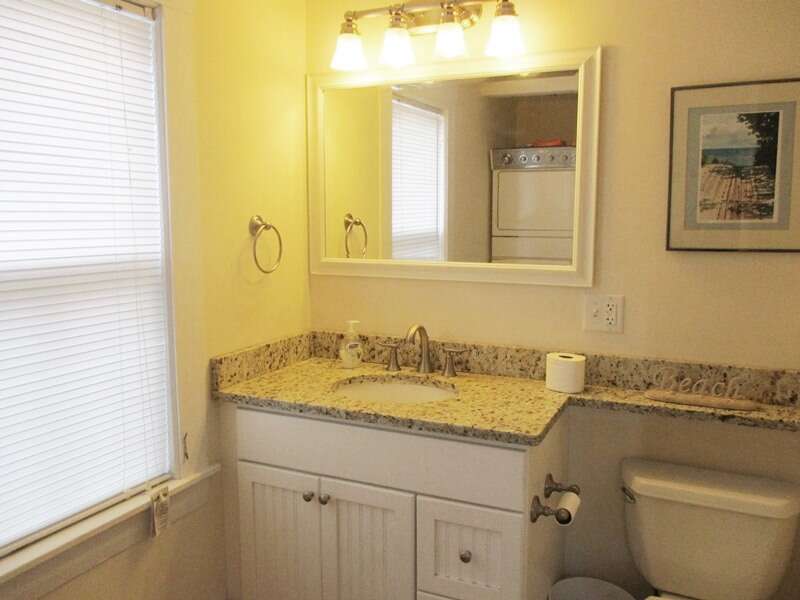 1st floor bathroom with a tub and shower located off of the kitchen - 36 Cross Street Harwich Port Cape Cod New England Vacation Rentals