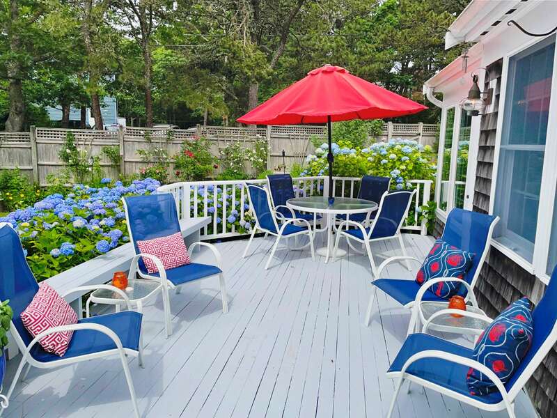 Outdoor deck with plenty of seating, table, umbrella and charcoal grill - 58 Longs Lane Chatham Cape Cod New England Vacation Rentals