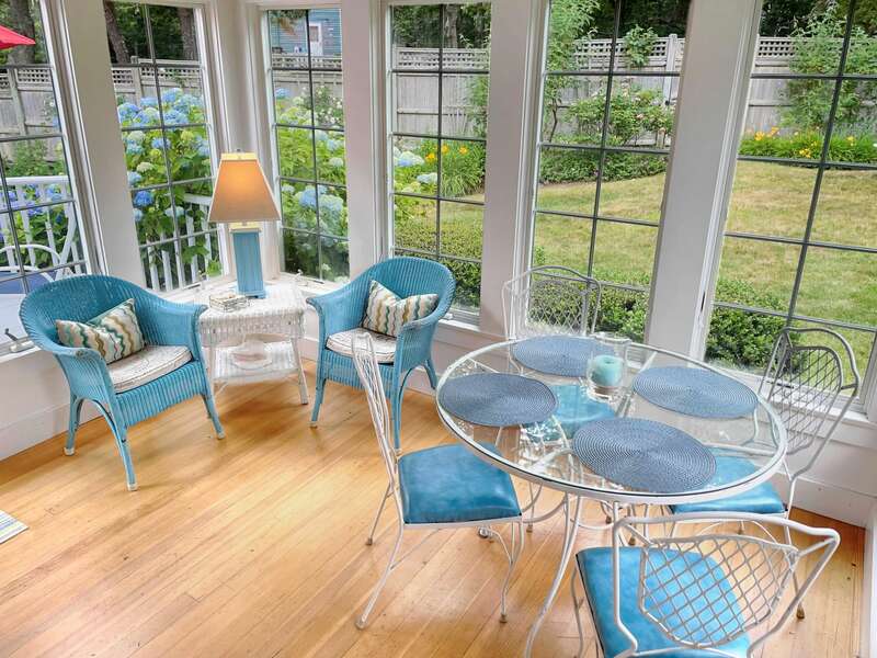 Sunroom with seating and small dining area. Offers easy access to deck - 58 Longs Lane Chatham Cape Cod New England Vacation Rentals