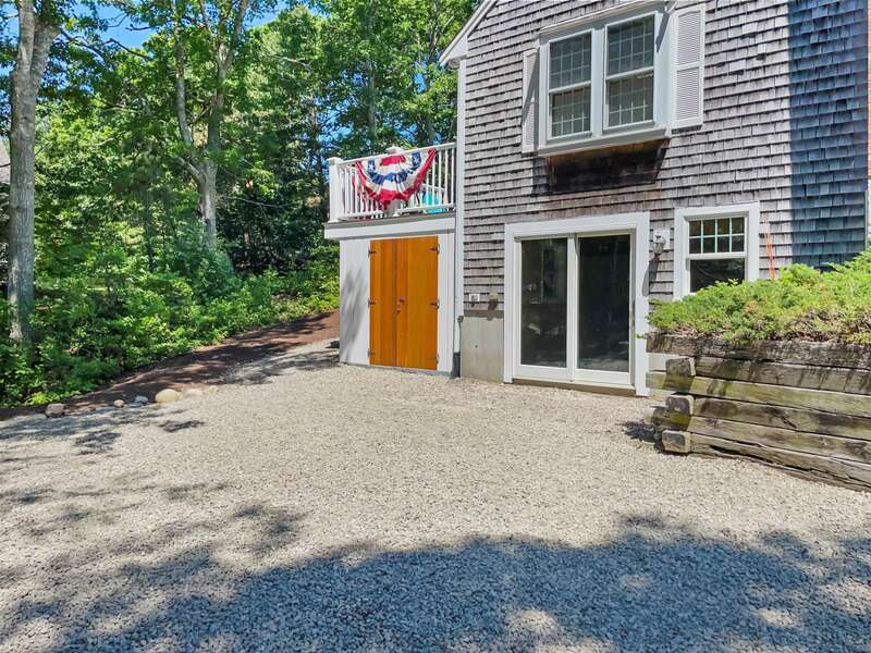 Expansive gravel driveway area to accommodate several cars and provide easy unloading of kayaks etc. into the storage space. 122 Tracy Lane Brewster Cape Cod New England Vacation Rentals