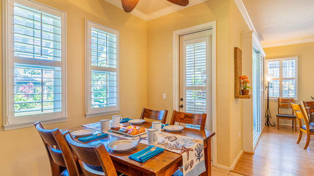 Dining area by the door to the back yard, with small table and chairs.