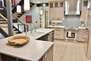 Gourmet display kitchen with stainless appliances and with Chef style culinary supplies