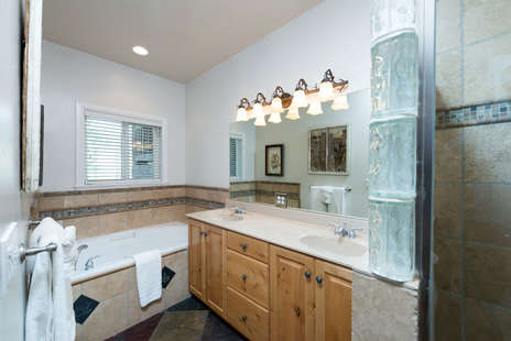 Attached master bathroom with jetted tub, separate shower, double vanity