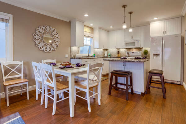 Dining Table, Chairs, Kitchen Island, Stools, Refrigerator, and Microwave.