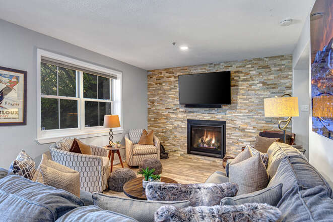 Main level living room with a sectional sofa, Smart TV and gas fireplace