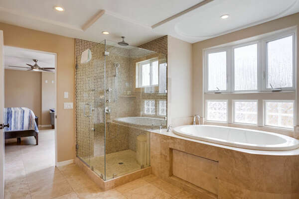 Bathroom with Bathtub and Shower with Glass Doors.