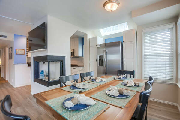 Dining Area with seating for six, fireplace, and view of living area.