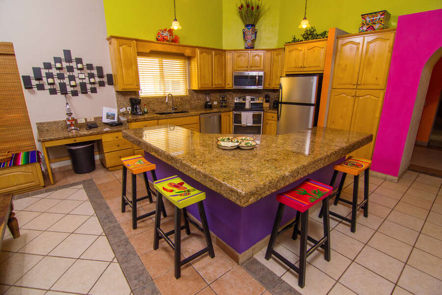 Generous kitchen space, with fun locally made bar stools, and plenty of room for cooking and snacking.