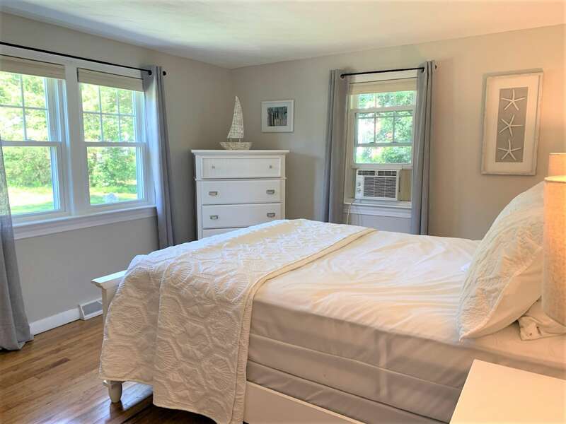 Bedroom #1 with Queen bed and dresser with window a/c unit.13 Carol Lane West Harwich Cape Cod New England Vacation Rentals