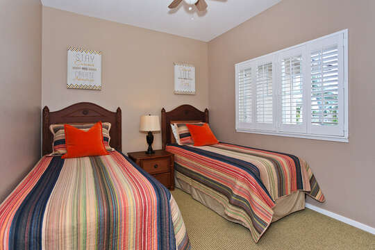 Third Bedroom and Den with Twin Beds, nightstand with lamp in-between.