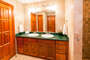 The guest bathroom features a shower and double sinks
