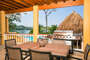 The bottom porch is open and has a palapa as well as a grill providing a great outdoor dining area.