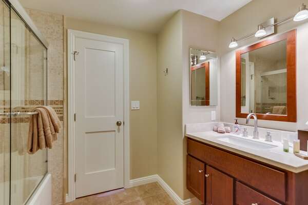 Single Sink Vanity, Mirror, and Shower-Tub Combo.