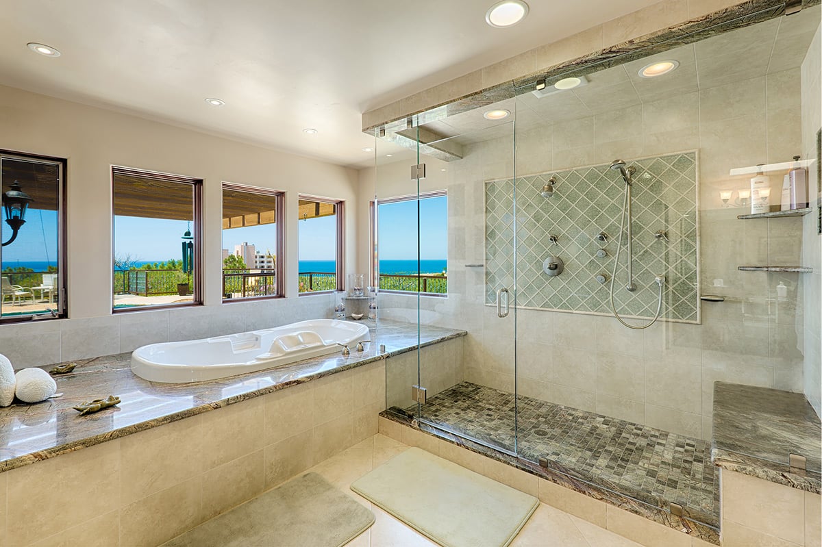 Master bathroom with jetted tub and spacious shower with ocean views