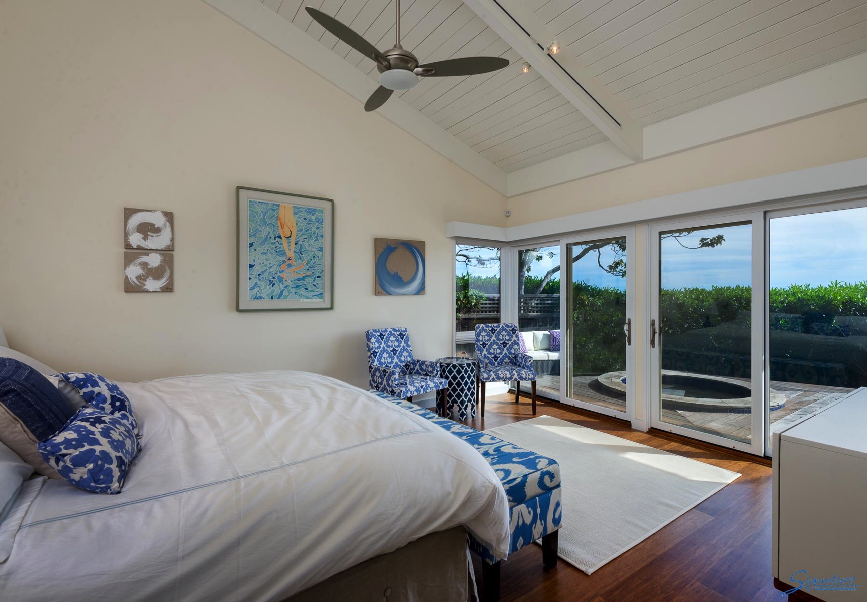 The master bedroom has views of the ocean and a deck with a sunken hot tub.