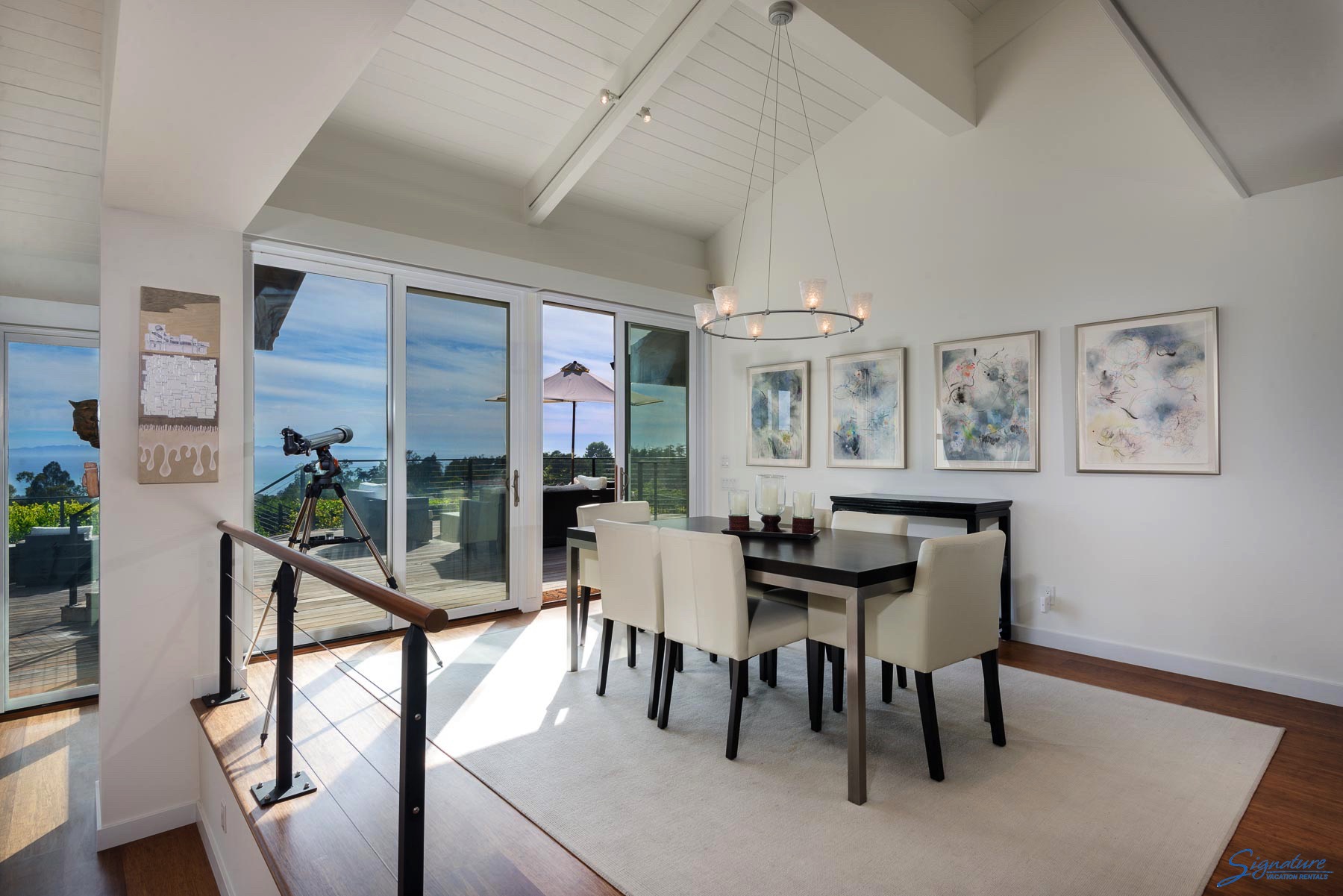 The dining area showcases the wonderful views and has a door to the deck