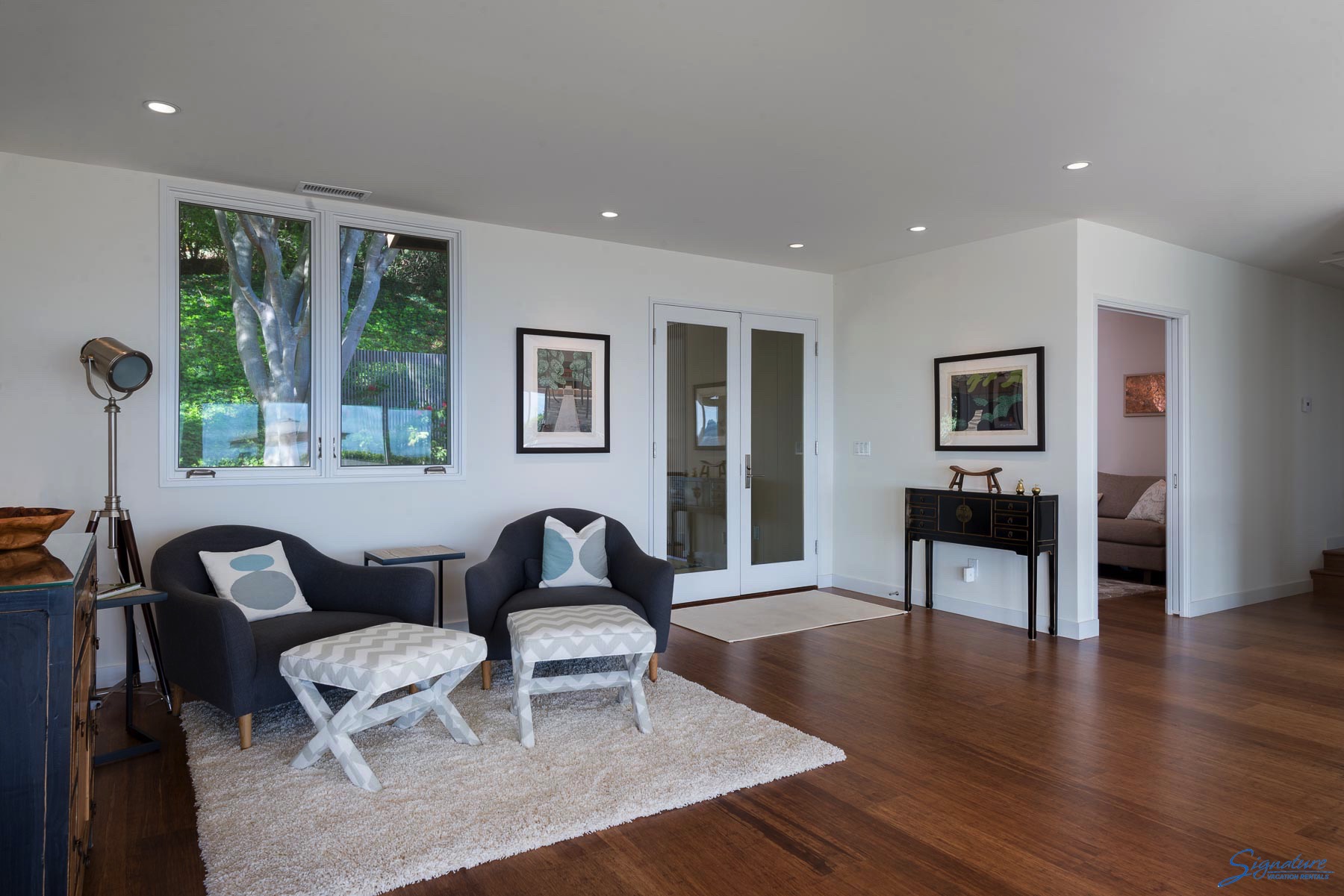 Beautiful wood floors throughout the home. This is a sitting area at the front entrance.